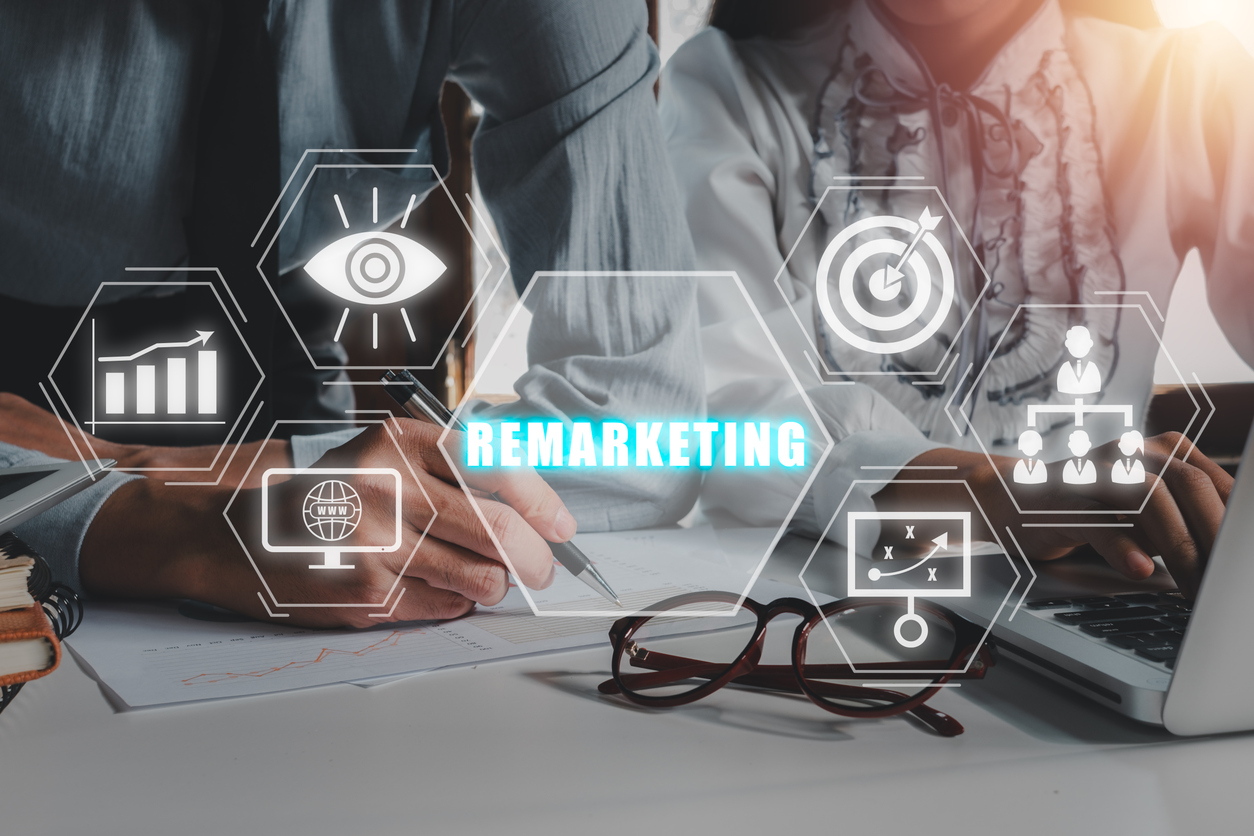 Team using digital tools with remarketing icons highlighting the benefits of remarketing for business growth.