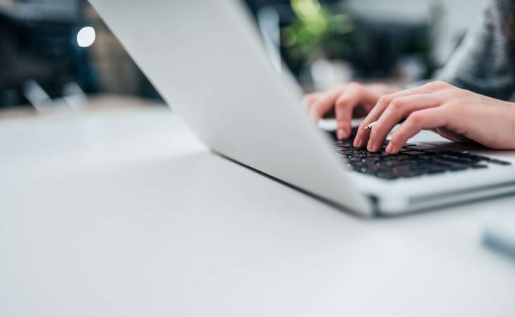 person typing on laptop